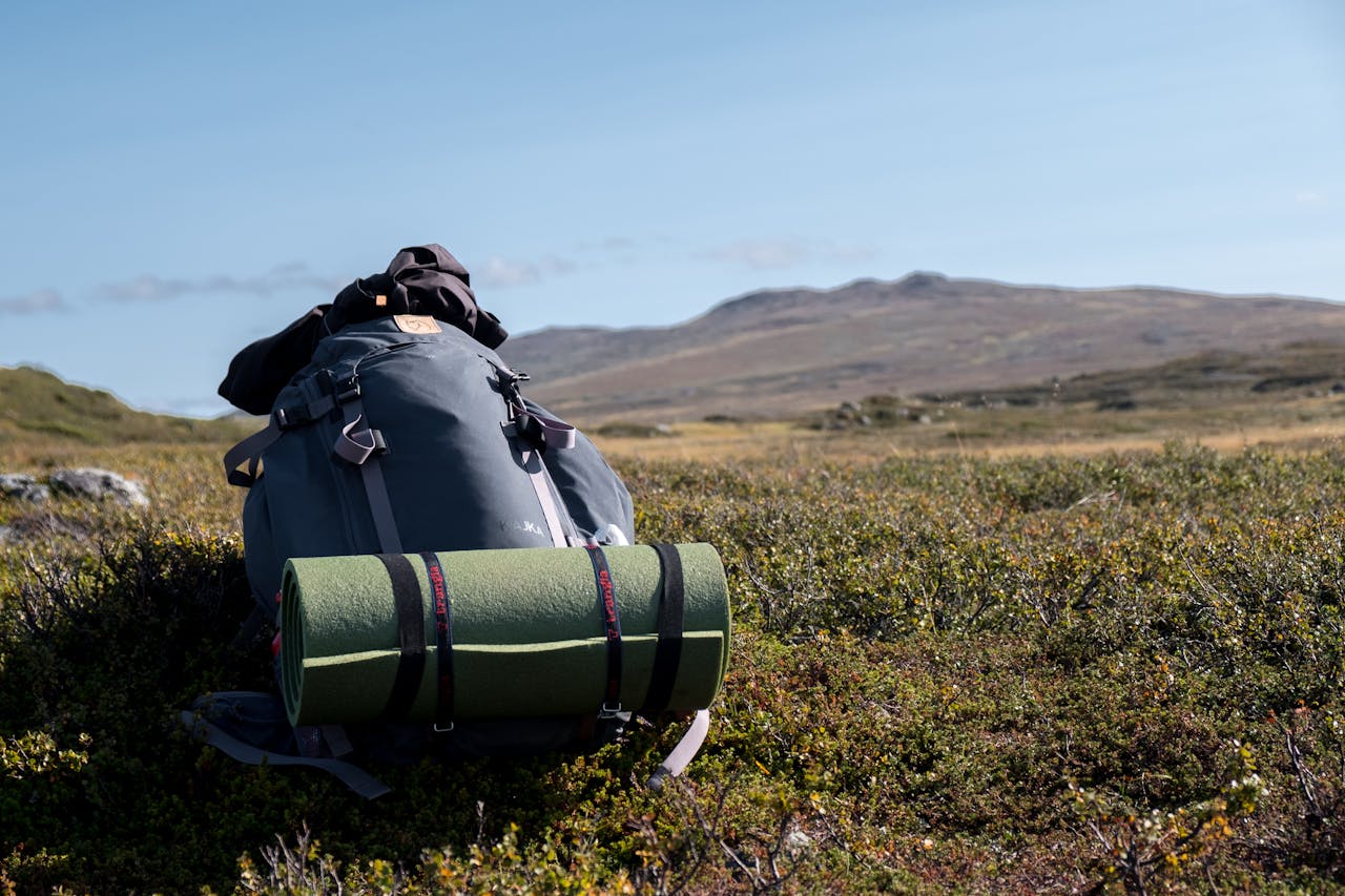 Backpack and camping gear in Sweden's scenic Jämtlands län mountains. Ideal for hiking and outdoor exploration.